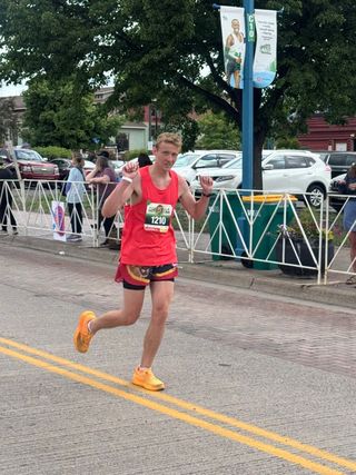 Christian running the final stretch of a road race